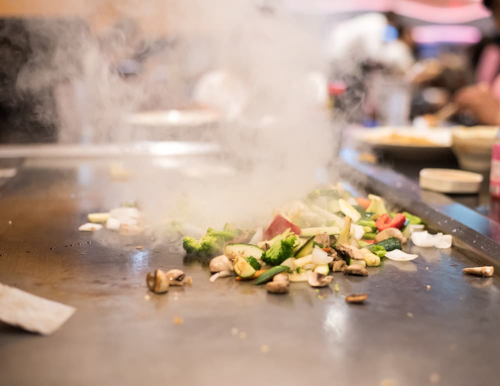 Fresh vegetables searing on the hibachi grill at Koji Express